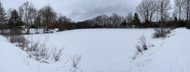 Large frozen lake with snow on top panorama